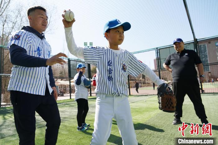 圖為教練指導小棒球手擲球技術?！●R銘言 攝