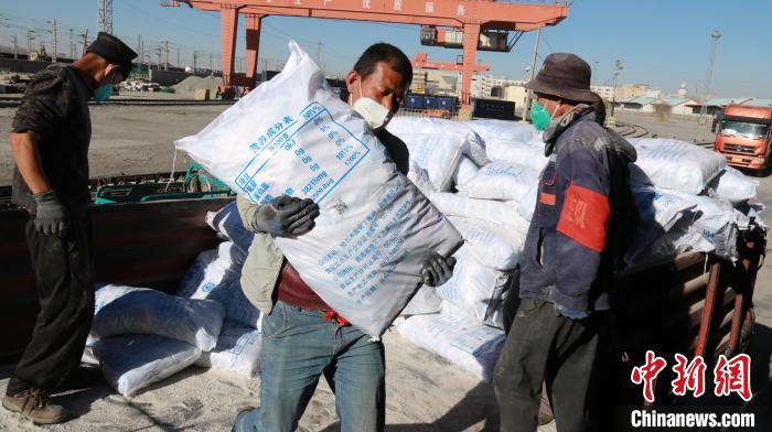 圖為裝卸人員將食鹽從汽車倒裝到火車上?！±钌?攝