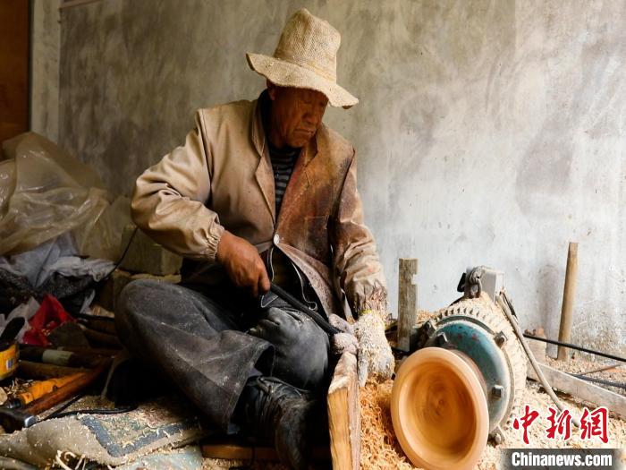 圖為手工藝人正在制作木碗?！?鄧海平 攝