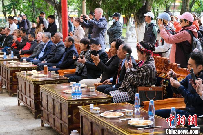 5月19日，中外嘉賓在羅布林卡和游客一起觀看藏戲。　江飛波 攝