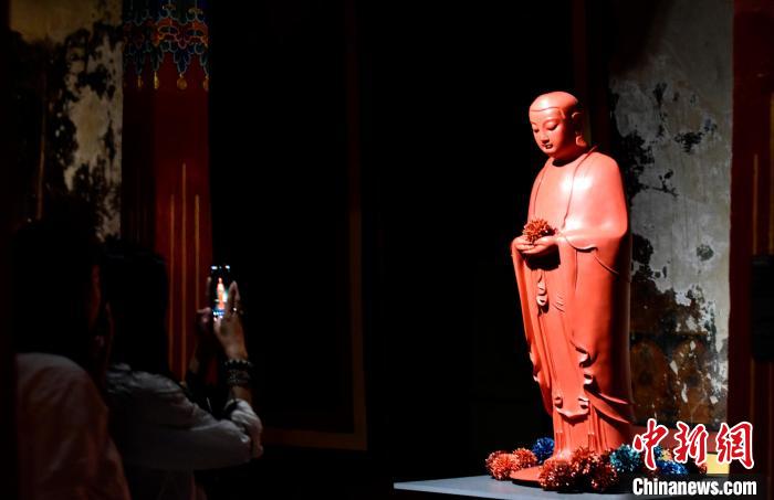 圖為觀眾正在欣賞展覽中的雕塑作品。