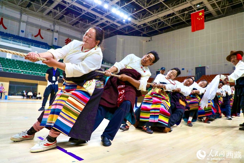 身著民族服裝的農(nóng)牧民選手在拔河比賽現(xiàn)場(chǎng)。