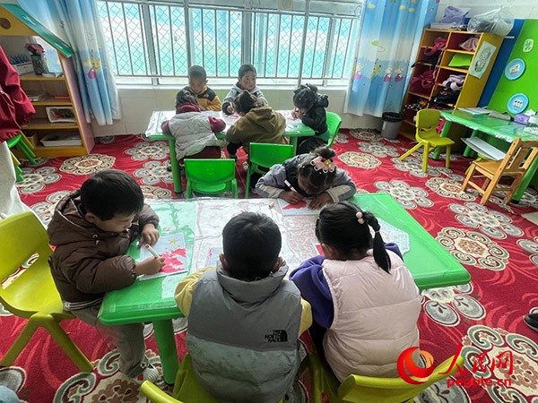 拉多村一所現(xiàn)代化幼兒園小班孩子們正在繪畫。張敏穎 攝